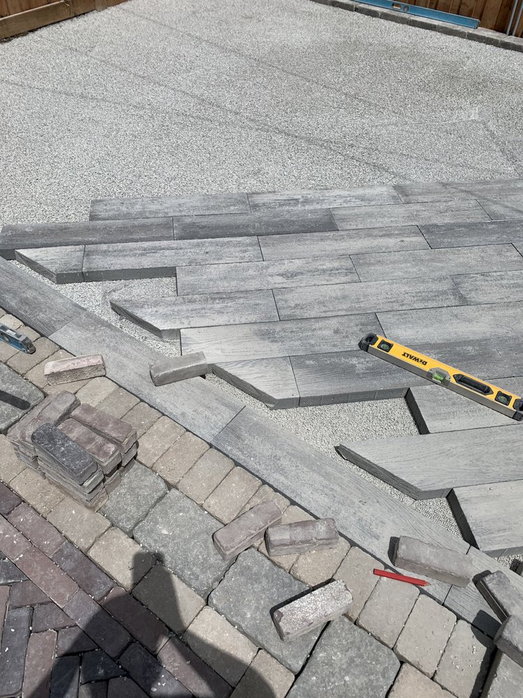 Long plank paver installation with level and sand base